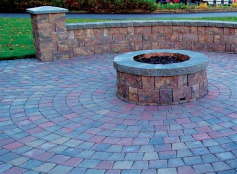 Many homes have fireplaces or propane stoves inside, but there's nothing quite like enjoying a fire pit under the stars in your own backyard. how to build a fire pit on top of pavers patio kits lowes ...