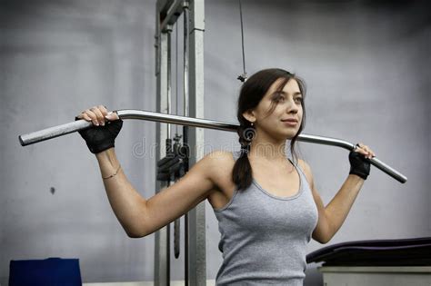 Young Woman Flexing Muscles On Cable Gym Machine Stock Photo Image Of