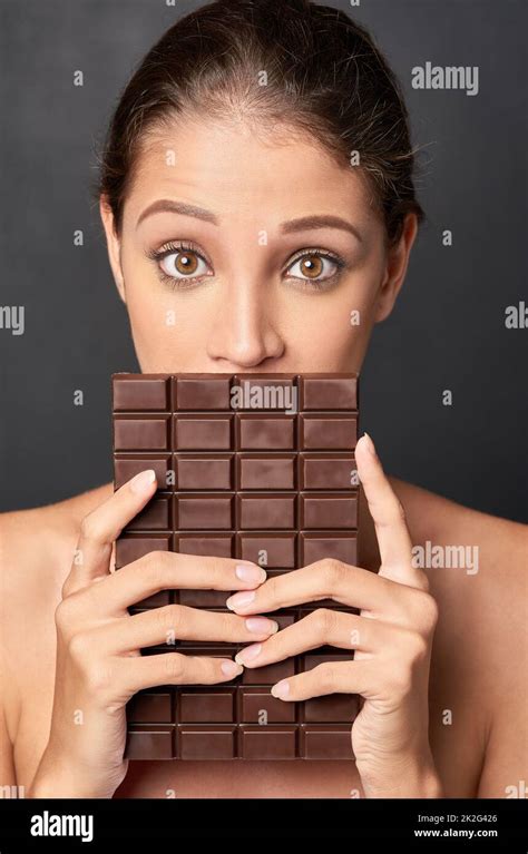 Shes A Lover Of Chocolate Studio Shot Of An Attractive Young Woman