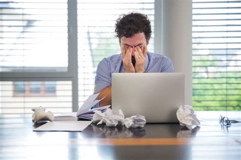 Man Looking Tired While Working Free Photo