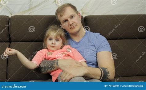 Father And Little Daughter Hugging Each Other On Sofa Fathers Day Stock Image Image Of Happy