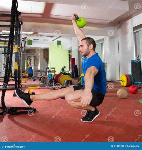 Crossfit Fitness Man Balance Kettlebells With One Leg Stock Photo