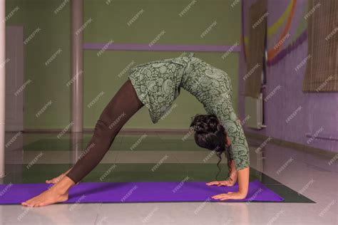 Premium Photo Yoga Instructor Works Yoga Exercises In The Gym