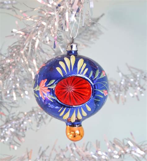 A Glass Ornament Hanging From A Christmas Tree