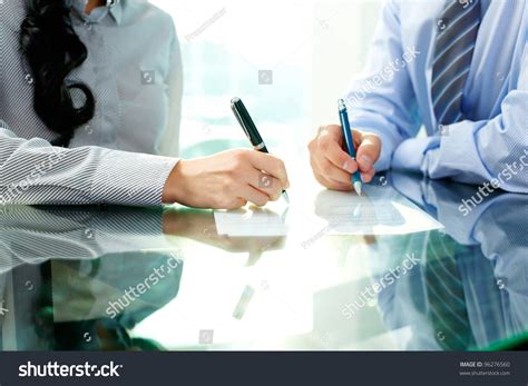 Two Business People Signing A Document Stock Photo 96276560 Shutterstock