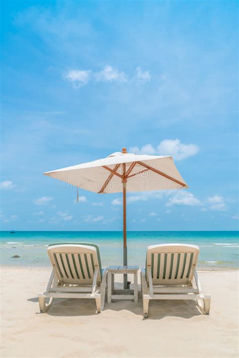 Beautiful Beach Chairs With Umbrella On Tropical White Sand Beach Stock