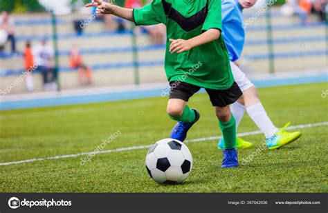 Young Boys Playing Football Game Young Players Kicking Soccer Ball