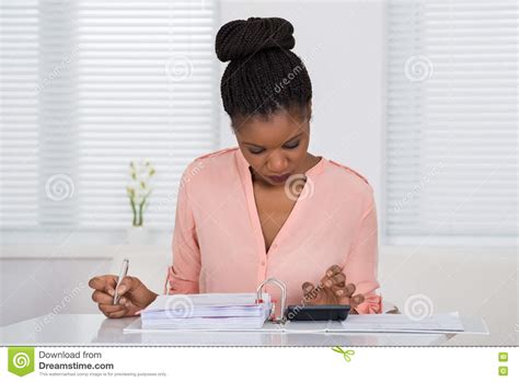 Woman Calculating Invoice With Calculator Stock Image Image Of Afro