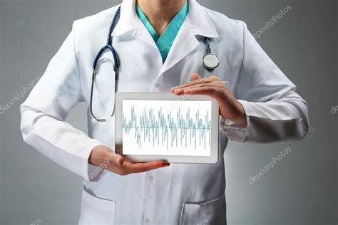 Doctor Holding Tablet In Hands Stock Photo By ©belchonock 104969752