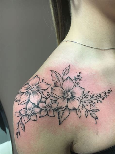 A Womans Shoulder With Flowers On It