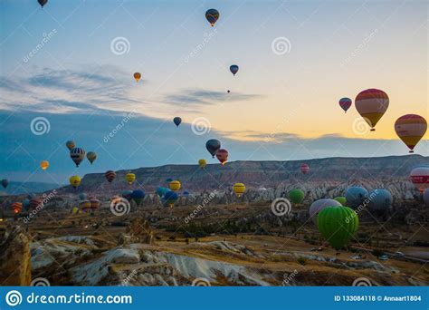 Hot Air Balloons Over Mountain Landscape In Cappadocia