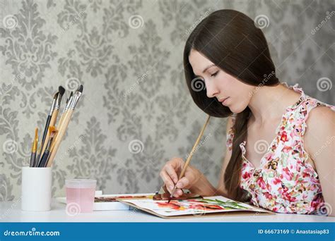 Young Woman Painter Drawing Watercolor Poppies At Her Home Studio Stock