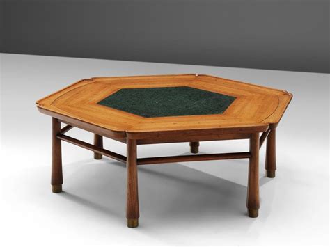 This vintage coffee table by drexel heritage features a hand painted frame with brass details on the feet. Drexel Heritage Hexagonal Coffee Table For Sale at 1stdibs
