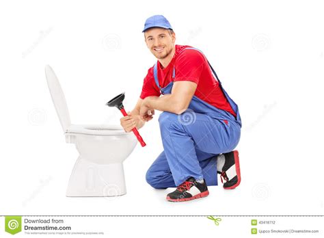 Male Plumber Sitting Next To A Toilet And Holding A Plunger Stock Photo