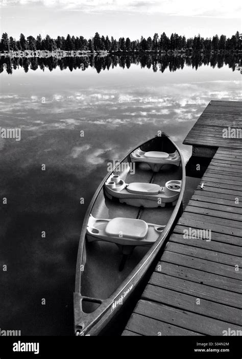 Canoe On Glassy Lake In Forest Bw Stock Photo Alamy