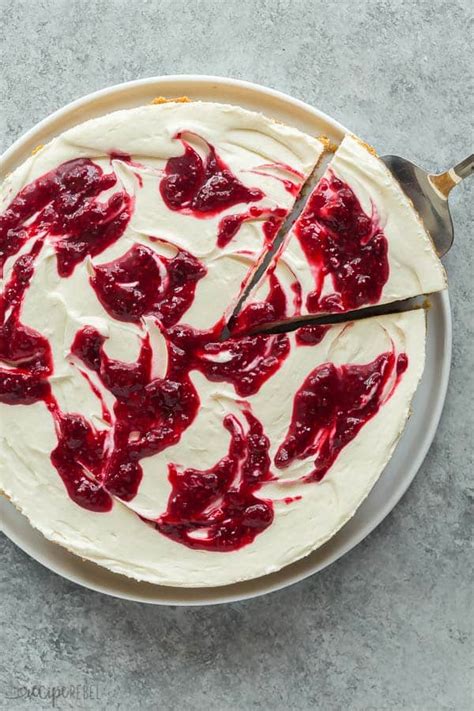 This white chocolate raspberry cheesecake is a creamy white chocolate cheesecake swirled with raspberry filling, all set in a chocolate cookie crust! No Bake White Chocolate Raspberry Cheesecake Recipe + VIDEO