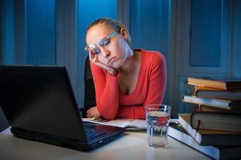 Young Bored Female College Student Studying Poorly At Late Evening