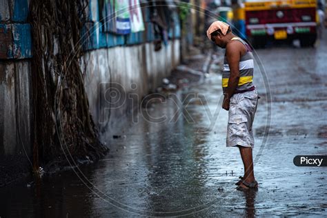 Image Of A Man Peeing Public Urination On Over Flooded Roads In Kolkata