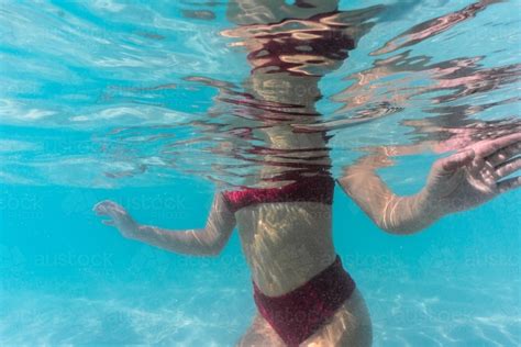 Image Of Body Of Woman In Red Bikini Kneeling Underwater In Peaceful