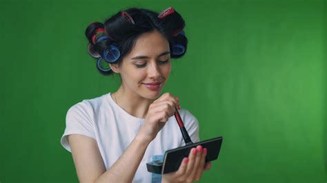 Girl In Curlers Doing Her Makeup Green Background Chromakey Stock Video Footage 00 14 Sbv