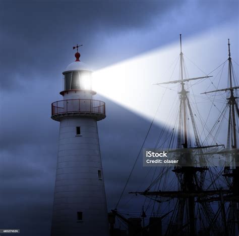 Lighthouse Beam Bad Weather And Old Ship Really Close Stock Photo