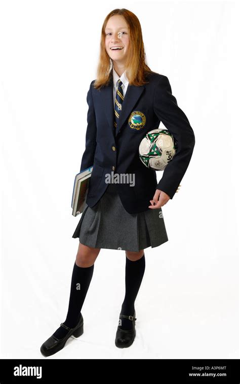 Smiling Young Girl In Private School Uniform With Books And Ball On