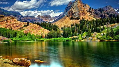 Landscape Nature Rocky Mountains With Jagged Peaks Pine Trees Mountain Lake Sky With White Cloud