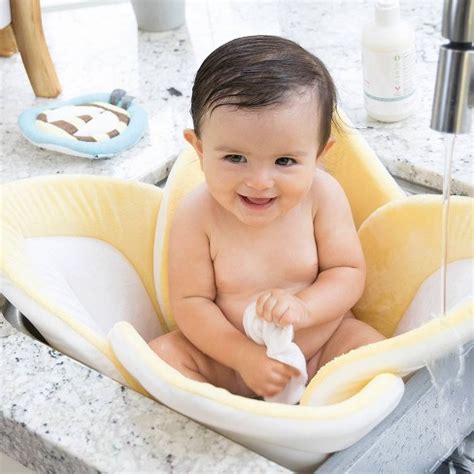 A groove in the front of the tub for easy placement of the shower head. Blooming Baby Lotus Bath Cushion - Pastel Yellow : Target