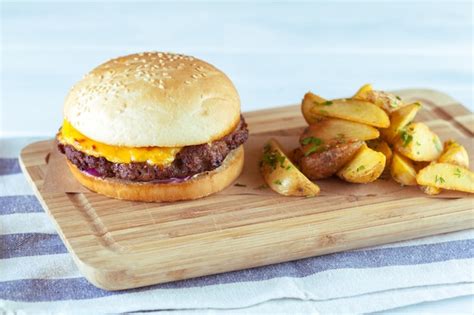 Premium Photo Burger And French Fries On Wooden Table
