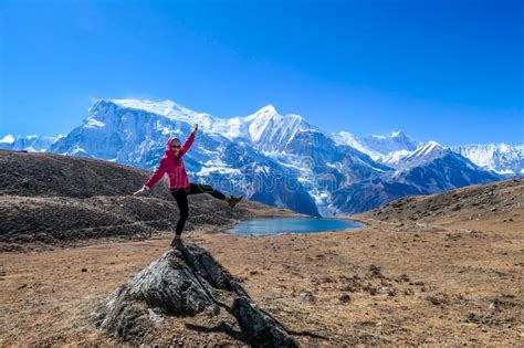 nepal girl balancing on a rock in the nearby of the ice lake annpurna circuit trek in