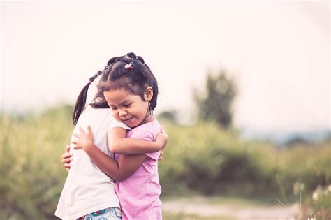 Two Asian Little Girls Hugging Each Other With Love Stock Photo