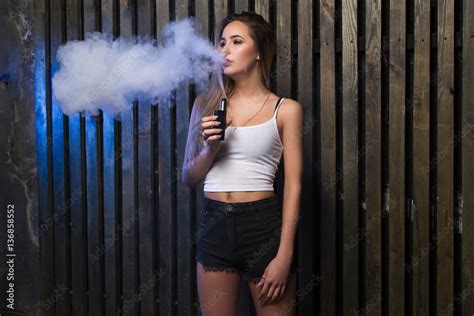 Foto Stock Young Beautiful Woman Smoking Vaping E Cigarette With
