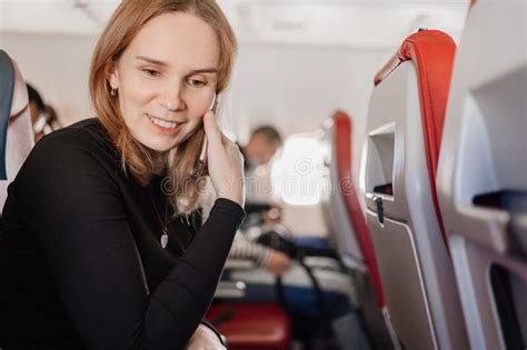 Woman Is Talking On The Phone In A Seat On Board The Plane Wifi For Passengers Stock Image