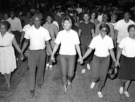 civil rights marchers walk through the streets of downtown cambridge maryland on may 12 1964