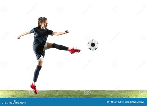 Female Soccer Player Kicking Ball Isolated Over White Background Stock