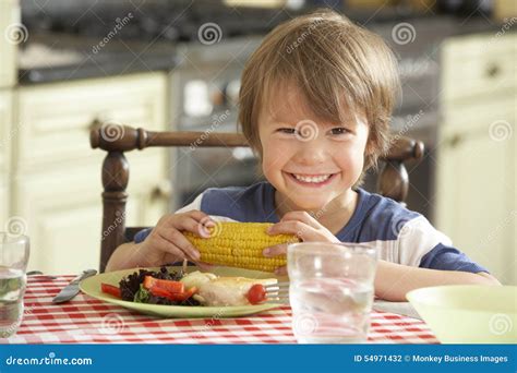 Young Boy Eating Meal In Kitchen Stock Photo Image Of Home Chicken