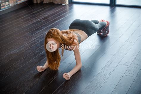 Portrait Of A Redhead Fitness Woman Doing Plank Exercise Royalty Free