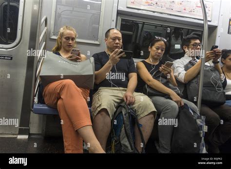 Riders Constantly Use Their Smartphones And Other Electronic Devices While Riding New York City