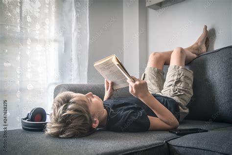 Blonde Boy Barefoot Reading Book Student Lying Down Learn The Lesson Comfortably Relaxed