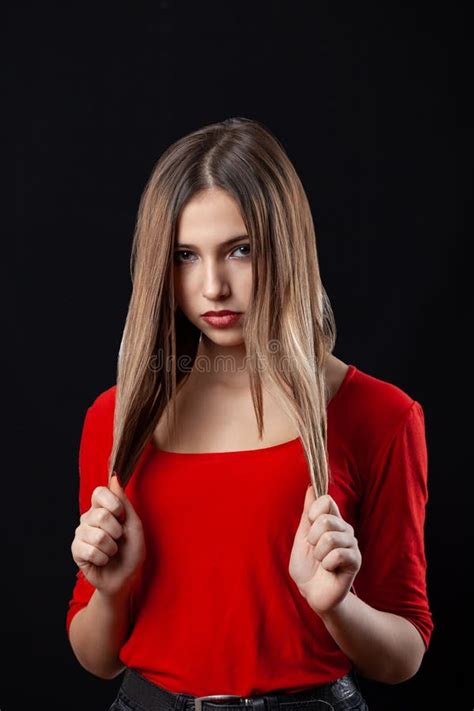 Beautiful Teenager Girl In Red Shirt Holding Her Hair On Black
