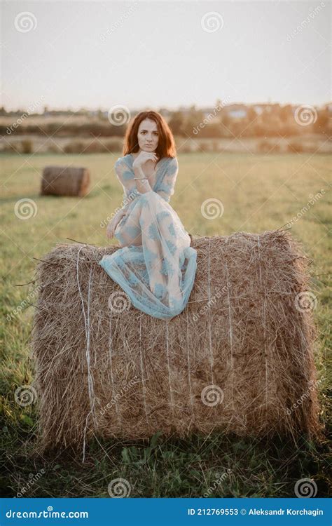 Girl In Underwear Posing On A Haystack In Summer At Sunset Stock Image