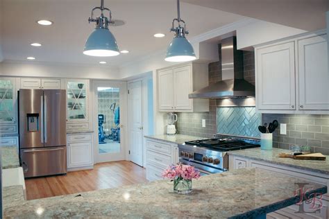 White and grey kitchen with clean lines and blue accents. #woodfloor #