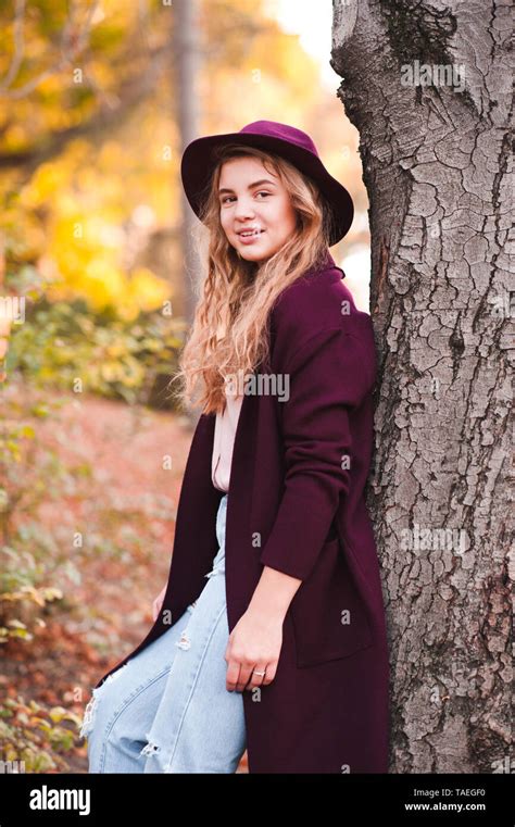Beautiful Blonde Teen Girl 14 16 Year Old Wearing Stylish Jacket Ant Felt Hat Leaning On Tree In