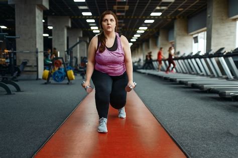 Premium Photo Overweight Woman Doing Exercise With Dumbbells In Gym Active Training