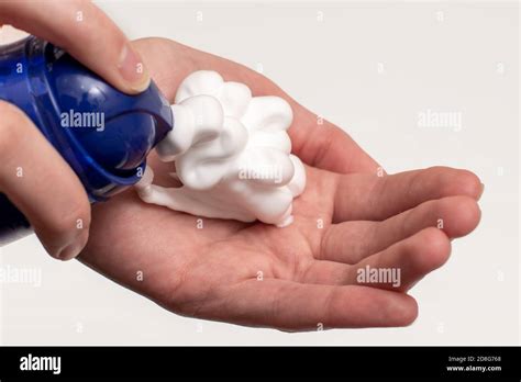 A Close Up Of A Female Hand Squeezing Foam In The Palm Of A Hand Place