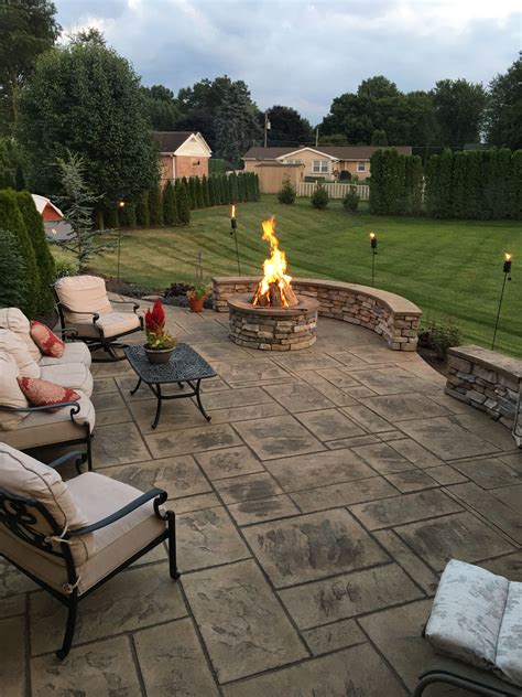 Stamped Concrete Patio With Stone Veneer Wall And Fire Pit Backyard
