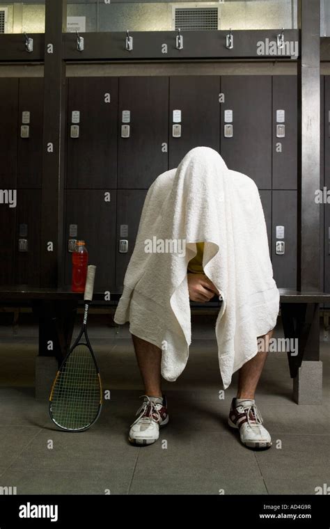 A Man Sitting In A Locker Room With A Towel Covering His Head Stock Photo Alamy