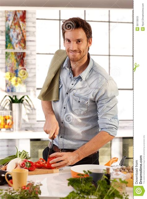 Send us a message to find out more. Happy Caucasian Man Cooking In Kitchen At Home Stock ...