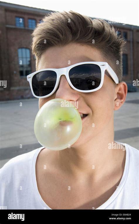 Teenage Boy Blowing Bubble Gum Stock Photo Alamy