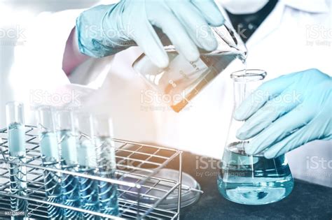 Scientist With Equipment Holding Tools During Scientific Experiment